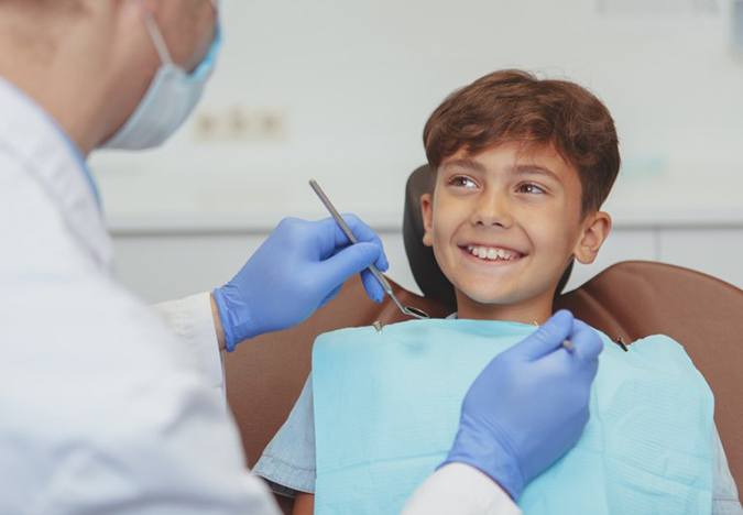 Child smiles at dentist