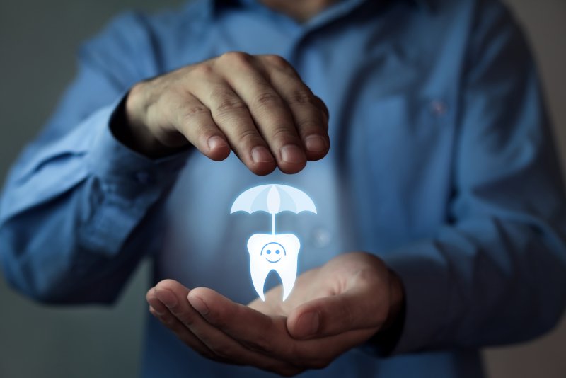 a person covering a tooth with an umbrella